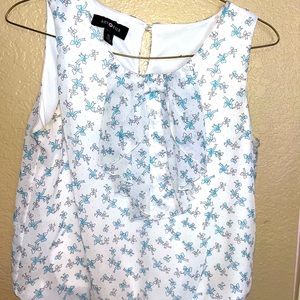 Beautiful blue and white flowy tank top adorned with a bow around the collar!